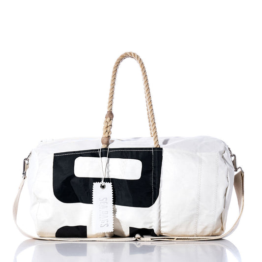 The Sea Bags Vintage 039 Duffel is a white vintage-style duffel bag featuring a black graphic print, hemp rope handles, a detachable shoulder strap, and a tag labeled Sea Bags. Crafted from recycled sail cloth, the bag is displayed against a white background. by Sea Bags