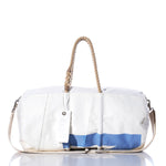 The Sea Bags Vintage Morris Duffel is crafted from recycled sail cloth and features hemp rope handles, a shoulder strap, and a distinctive blue stripe design on the lower front. A white SEABAGS tag is attached to one handle. by Sea Bags