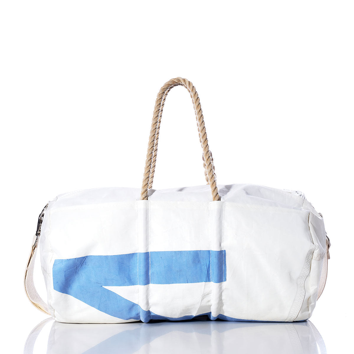 The Sea Bags Vintage Morris Duffel, crafted from recycled sail cloth in white and blue and featuring sturdy hemp rope handles, is displayed on a white background with its reflection visible on a shiny surface. by Sea Bags