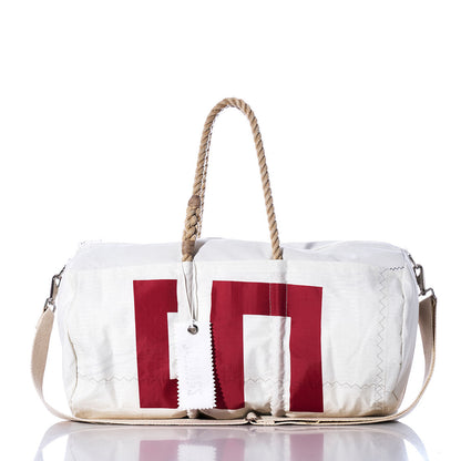 The Sea Bags Vintage 539 Duffel is a white duffel bag accented with bold red block-style lettering, featuring sturdy hemp rope handles and a beige shoulder strap, displayed on a white background. by Sea Bags