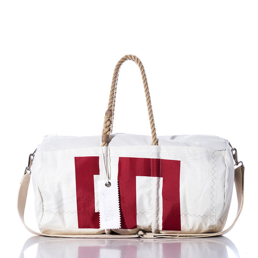 The Sea Bags Vintage 539 Duffel is a white duffel bag accented with bold red block-style lettering, featuring sturdy hemp rope handles and a beige shoulder strap, displayed on a white background. by Sea Bags