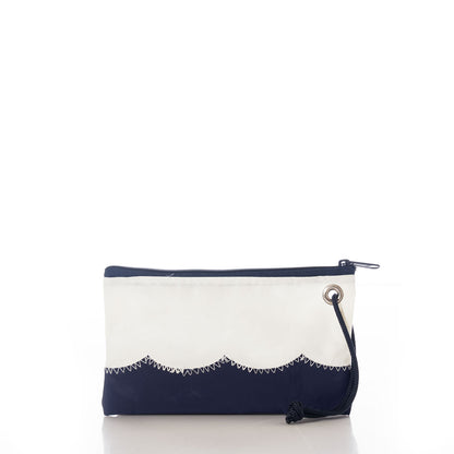 The Wavy Seas Wristlet by Sea Bags is a rectangular zippered pouch featuring a navy blue bottom, white top, scalloped seam, metal grommet, and navy wrist strap. Displayed on a white background, this sustainable accessory effortlessly captures nautical style. by Sea Bags