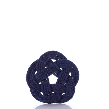 A set of Nautical Sailor Knot Coasters in navy by Mystic Knotwork is displayed upright on a white surface against a plain white background, highlighting the classic craftsmanship of the brand.