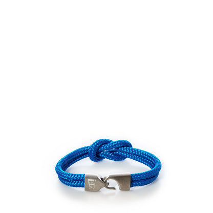 A Lemon  Line Square Knot Bracelet in blue, featuring a braided rope design and silver metal hook clasp, displayed on a white background—an ideal summer accessory. by Sea Bags