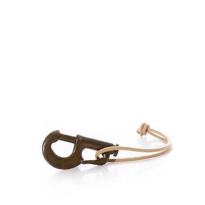 Vintage Sailing Hardware brass jib hank snap hook attached to a tan cord loop.