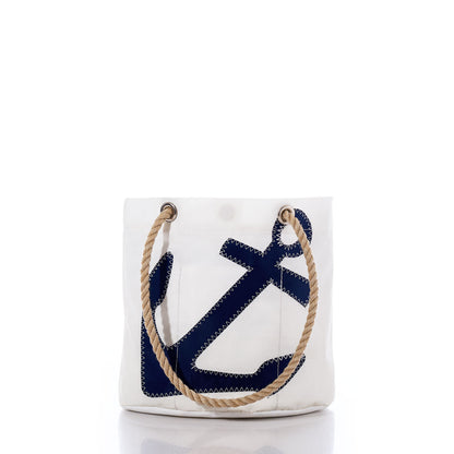 The Sea Bags Navy Anchor Essential Handbag is a white tote featuring a navy blue anchor design and tan rope handles, expertly crafted from recycled sail cloth for a stylish and sustainable accessory. Shown against a plain white background. by Sea Bags