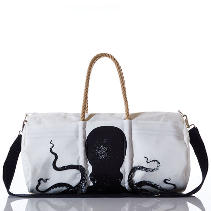 The Sea Bags Octopus Duffel is crafted from recycled sail cloth and showcases a bold black octopus design. It features marine-grade zippers, durable rope handles, a black shoulder strap, and is photographed against a white background. by Sea Bags