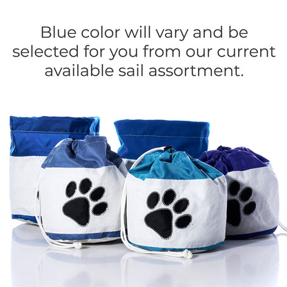 Five Sea Bags Paw Print Ditty Bags are displayed in a mix of blue and white fabrics, each with a black paw print design and convenient drawstring closure. These eco-friendly accessories are ideal for storing pet treats or toys. Please note: the shade of blue may vary depending on current stock. by Sea Bags
