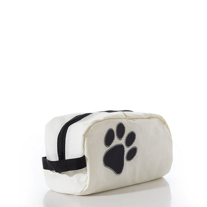 The Paw Print Toiletry Bag by Sea Bags is a white zippered pouch featuring a black paw print design on the side, crafted from recycled sail cloth and displayed against a plain white background—making it an ideal travel kit for dog lovers. by Sea Bags
