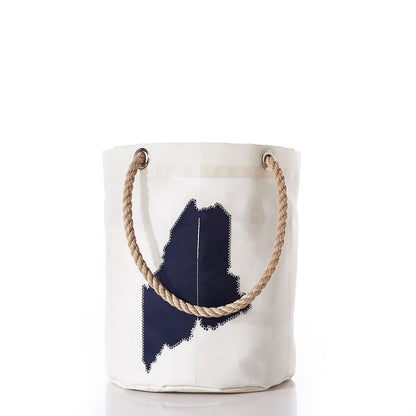 The State of Maine Beverage Bucket by Sea Bags features a white canvas design crafted from recycled sail cloth, accented with sturdy rope handles and a dark blue patch shaped like the state of Maine on the front, shown against a plain white background. by Sea Bags