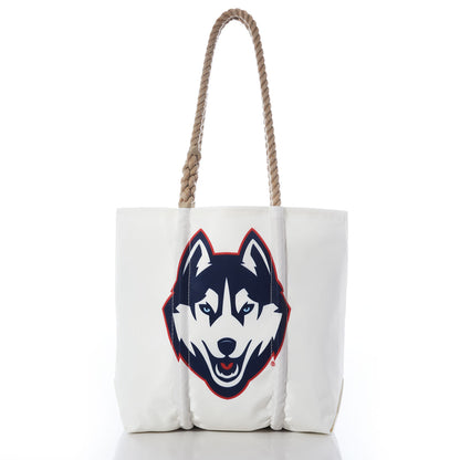 Introducing the UCONN Tote by Sea Bags—a white tote bag with sturdy hemp rope handles, featuring a large graphic of a husky dog’s face outlined in navy and red on the front. Finished with a collegiate hang tag for added style. by Sea Bags