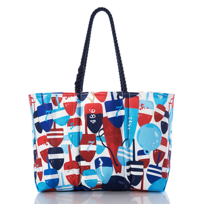 The Sea Bags Americana Buoys Large Tote is a spacious bag with hemp rope handles, featuring a vibrant pattern of red, blue, and white nautical buoys on a crisp white background. by Sea Bags