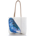 The Blue Mussel Shell Tote by Sea Bags features tan rope handles and a blue mussel shell illustration on one side, inspired by Maine seafood. Photographed against a white background, this environmentally-friendly accessory celebrates the beauty of mussel shells while offering everyday practicality. by Sea Bags