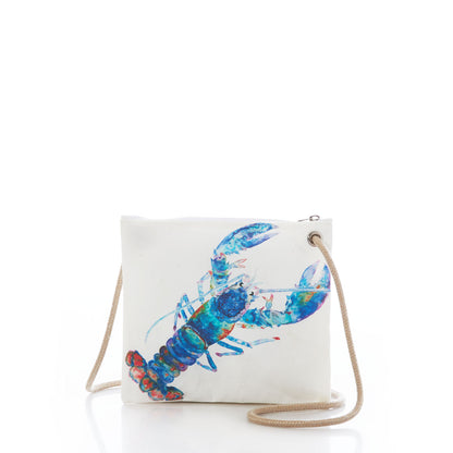 Sea Bags Multicolor Lobster Slim Crossbody—crafted from recycled sail cloth for an eco-friendly, sustainable design—features a square white canvas body, a vibrant blue and red lobster illustration, a top zipper closure, and a tan rope shoulder strap. Displayed on a white background. by Sea Bags