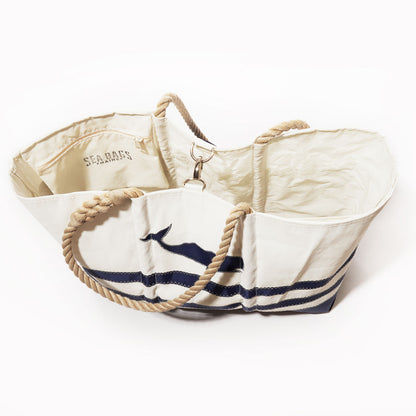 Navy whale graphic adorns the Breton Stripe Whale Ogunquit Beach Tote by Sea Bags, crafted from recycled sail cloth for eco-friendly style; this spacious white tote features rope handles and an interior pocket—perfect for nautical beach outings. by Sea Bags