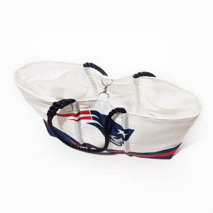 The New England Patriots Tailgate Tote by Sea Bags, crafted from recycled sail cloth, features navy blue rope handles and a bold Patriots logo printed on the side, displayed against a white background. by Sea Bags