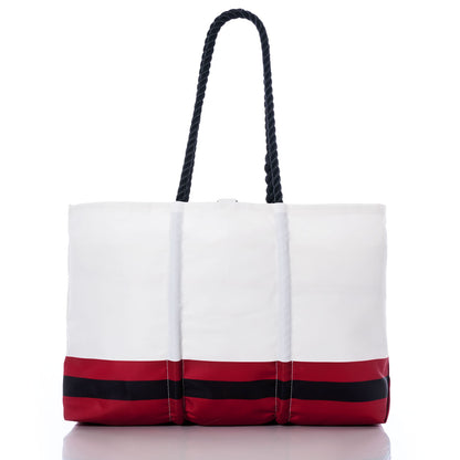 Atlanta Falcons Tailgate Tote by Sea Bags, crafted from recycled sail cloth, features bold red and black horizontal stripes along the bottom and sturdy black rope handles. Photographed on a white background, this eco-friendly tote showcases Atlanta Falcons spirit with a stylish and sustainable design. by Sea Bags