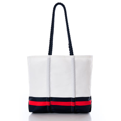 The Houston Texans Medium Tote by Sea Bags is a white tote bag crafted from recycled sail cloth, featuring black rope handles and accented with bold black and red horizontal stripes near the base. Displayed on a plain white background, this stylish accessory is perfect for any Houston Texans fan’s collection. by Sea Bags