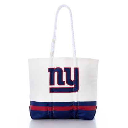 Introducing the New York Giants Medium Tote by Sea Bags—a stylish accessory crafted from recycled sail cloth. This white tote features bold blue and red stripes at the base, a prominent NY logo on the front, and two sturdy white rope handles, creating a unique NFL-inspired bag that perfectly blends team spirit with sustainability. by Sea Bags