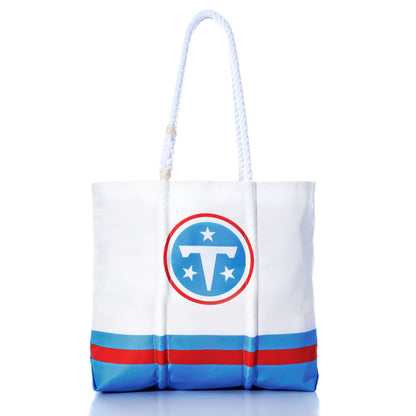 Introducing the Sea Bags Tennessee Titans Medium Tote—crafted from white recycled sail cloth with navy handles and blue stripes, featuring the official team logo prominently on the front. An ideal eco-friendly bag for dedicated Titans fans. by Sea Bags