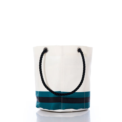 The Jacksonville Jaguars Beverage Bucket by Sea Bags is a white bucket bag accented with black and teal stripes at the bottom—echoing the teams iconic colors. It features a thick black rope handle and is photographed against a white background. by Sea Bags