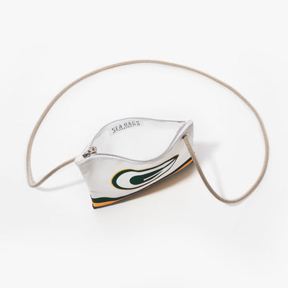 The Sea Bags Green Bay Packers Slim Crossbody is a small white zippered pouch, featuring a beige cord strap and made from recycled sail cloth. The bag showcases a stylized green and yellow Green Bay Packers logo design and is photographed on a white background. by Sea Bags