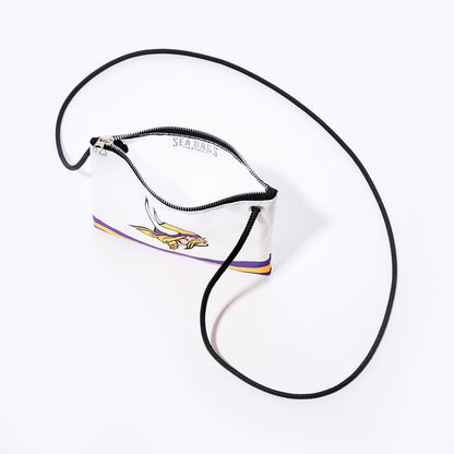 Show your Minnesota pride with the Sea Bags Minnesota Vikings Slim Crossbody—a white zippered pouch with a black strap, adorned with purple and yellow stripes and a stylized Viking head logo. Crafted from durable, recycled sail cloth, this versatile crossbody bag is both eco-friendly and perfect for fans on the go. Displayed on a white background. by Sea Bags