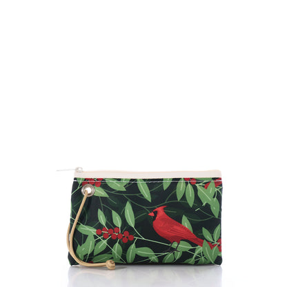 Introducing the Winterberry Cardinals Wristlet by Sea Bags—a small zippered pouch crafted from recycled sailcloth, adorned with a red cardinal and green leaves on a black background, and finished with a beige strap. Perfect as a festive holiday wristlet or one-of-a-kind gift card holder. by Sea Bags