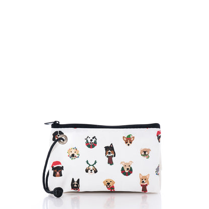 The Very Merry Pups Wristlet by Sea Bags is a white zippered pouch with black trim, adorned with cartoon dog faces in festive holiday accessories and photographed on a white background—an ideal eco-friendly gift pouch for any dog lover. by Sea Bags