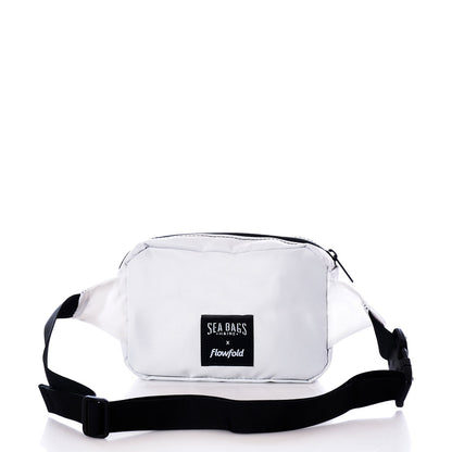 A sustainable belt bag in the Navy Anchor design, crafted from recycled sail cloth by Sea Bags, featuring a black adjustable strap and a front label reading Sea Bags, photographed on a white background. by Sea Bags
