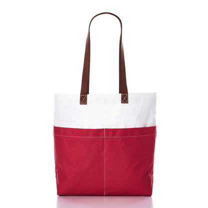 The Sea Bags Red Chebeague Market Tote, featuring brown leather handles, is crafted from recycled sails and displayed upright on a white background. by Sea Bags