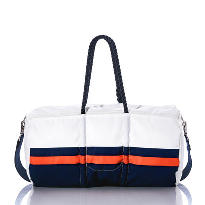 The Denver Broncos Duffel by Sea Bags features a white exterior with navy and orange horizontal stripes, black rope handles, and a detachable shoulder strap. Crafted from recycled sail cloth and displayed on a reflective surface, this stylish bag is the perfect accessory for any Denver Broncos fan. by Sea Bags