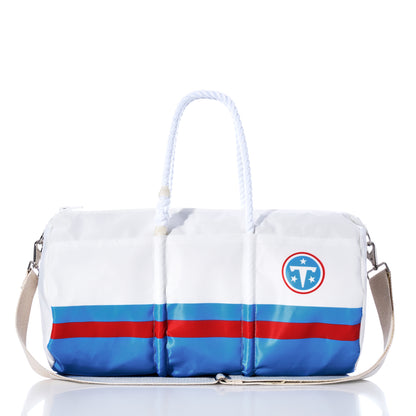 Sea Bags Tennessee Titans Duffel crafted from recycled sail cloth, featuring blue stripes, rope handles, a shoulder strap, and the Tennessee Titans logo in white and navy, displayed against a white background. by Sea Bags