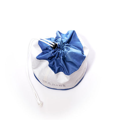 The Sea Bags Ditty Bag, crafted from recycled sail bags in blue and white, features a cord lock closure at the top and is displayed on a white background. by Sea Bags