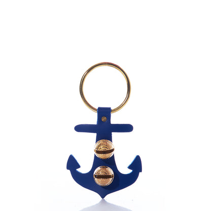 A gold key ring is attached to the Navy Anchor Door Chime by New England Bells—a blue, nautical anchor-shaped keychain adorned with two gold decorative studs on the front, evoking classic maritime style.