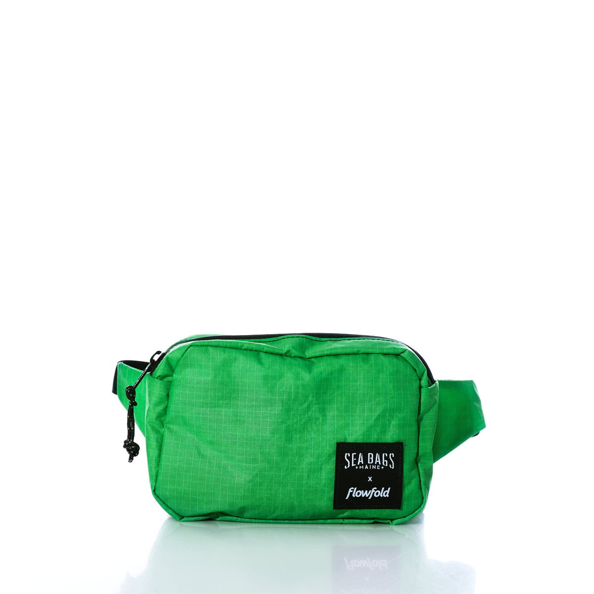 Introducing the Vintage Lime Green Crew Belt Bag by Sea Bags—a small, bright green waist bag crafted from recycled sail cloth. It features a black zipper, adjustable strap for a comfortable fit, and a prominent black patch on the front labeled “Sea Bags x Flowfold.”. by Sea Bags