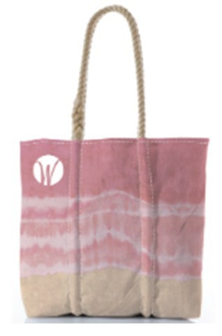 The Shoreline Blush Medium Tote by Sea Bags is a canvas tote bag made from recycled sailcloth, featuring rope handles and pink and beige tie-dye patterns, with a small white circular logo in the upper left corner. by Sea Bags
