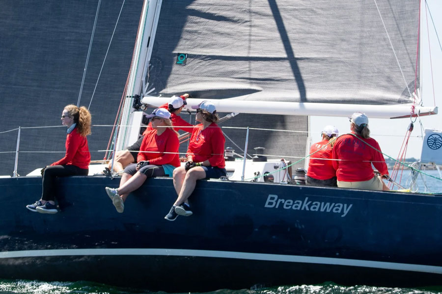 Sea Bags Womens Sailing Team sitting on the rail of the J35 Sailboat