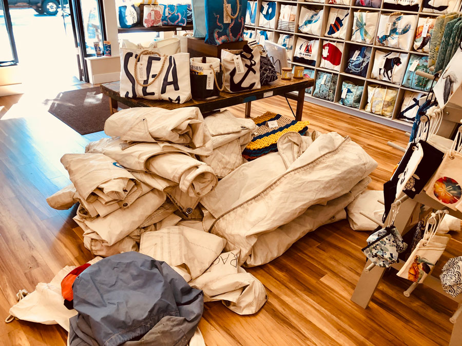A pile of sails sits in the middle of the Sea Bags store in Charlevoix. These sails will soon be recycled into sail cloth totes and accessories.