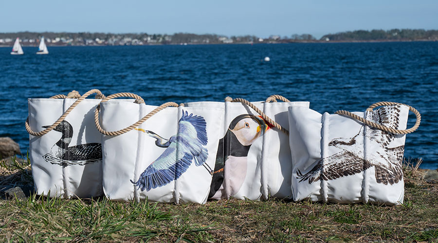 American Bird Collection totes lined up on waterfront