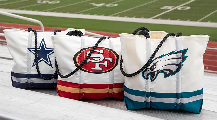 NFL Totes lines up on bleachers at a football field