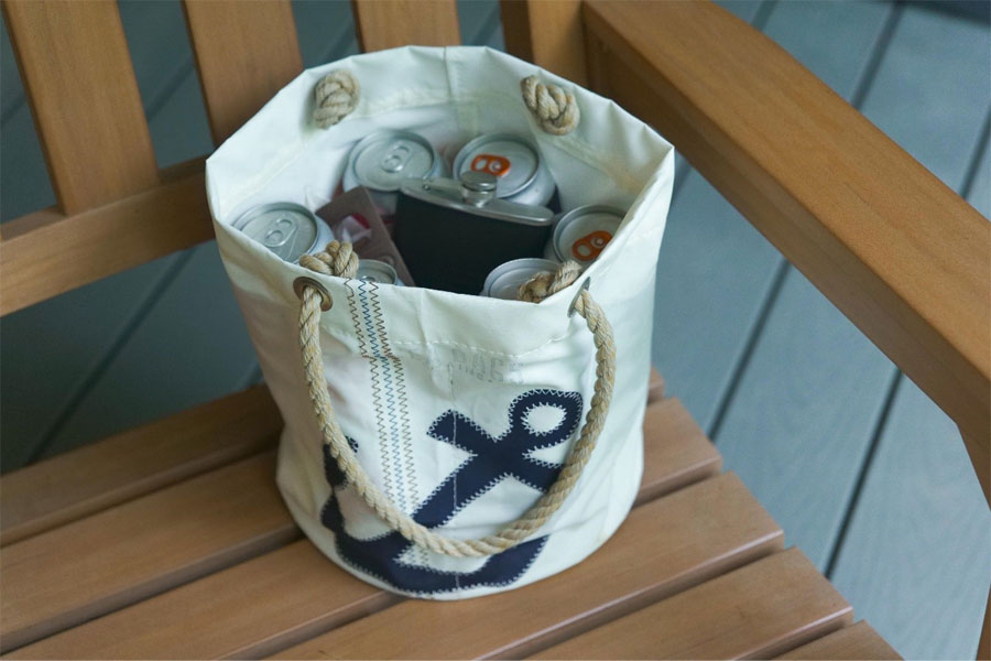 The Sea Bags Navy Anchor Beverage Bucket is used as a thank you gift for the groomsmen. It holds local craft beer, a flask, and a bottle opener.