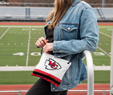 Woman at a football game wearing NFL Kansas City Chiefs Crossbody