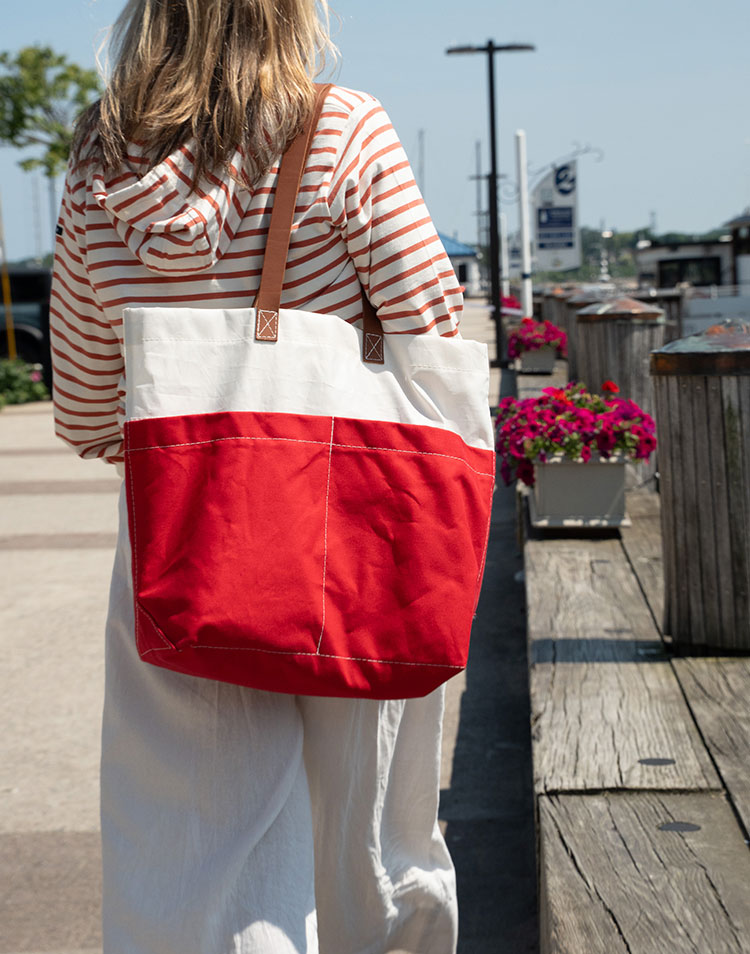 NEW Chebeague Red Market Tote held my woman walking on pier near boats