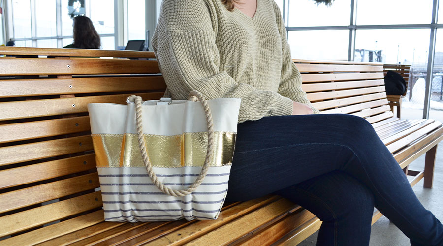 Gold Stripe Handbag on a bench