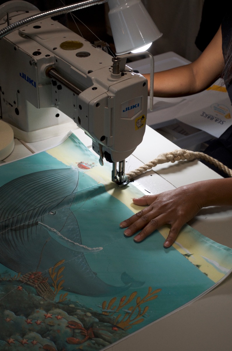 Chris Van Dusen's illustrations are transformed onto a recycled sail cloth tote at Sea Bags' headquarters