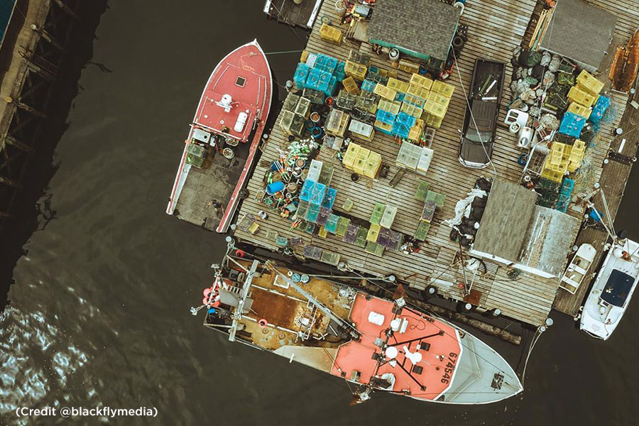 Overhead looking at fishing boats next to a wharf