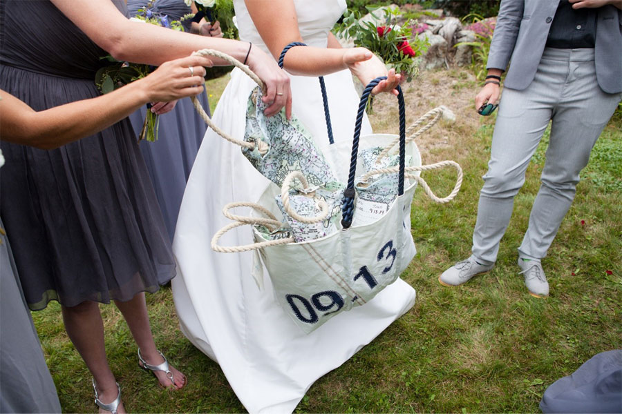 A Custom Sea Bags Date Tote is used to store many Sea Bags Wine Bags. Guests are each taking a wine bag as a sustainable wedding favor.