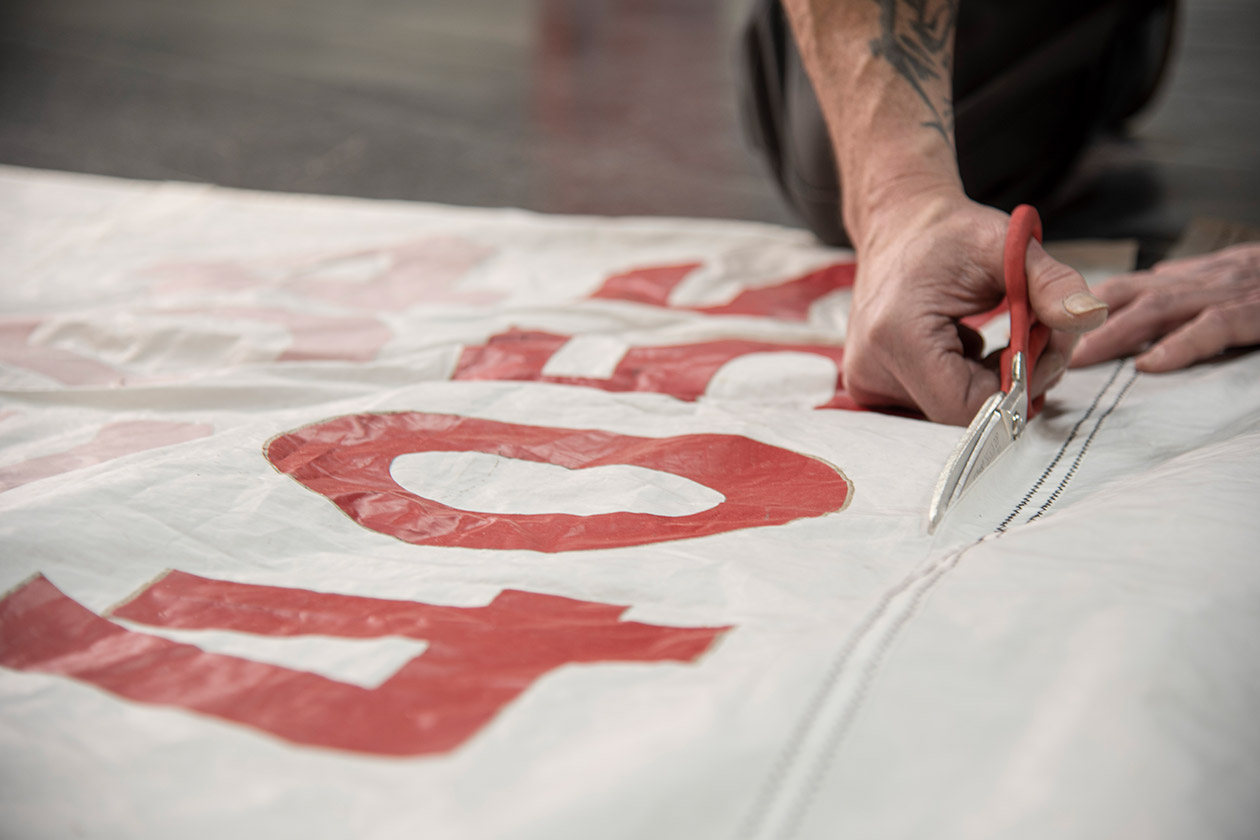 Hand cutting sails to be made into tote bags and accessories.