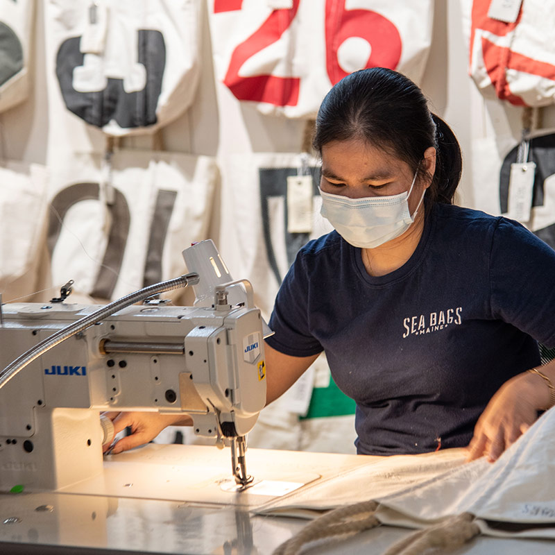 Sea Bags seamstress doing a stitching demo at our new flagship store